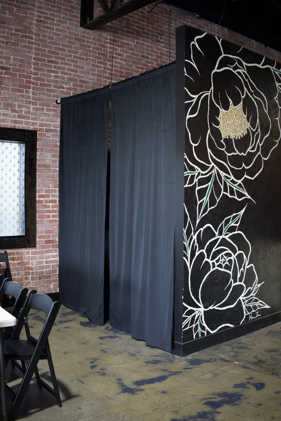 Arched entryway with hanging plants in renovated Boise event space