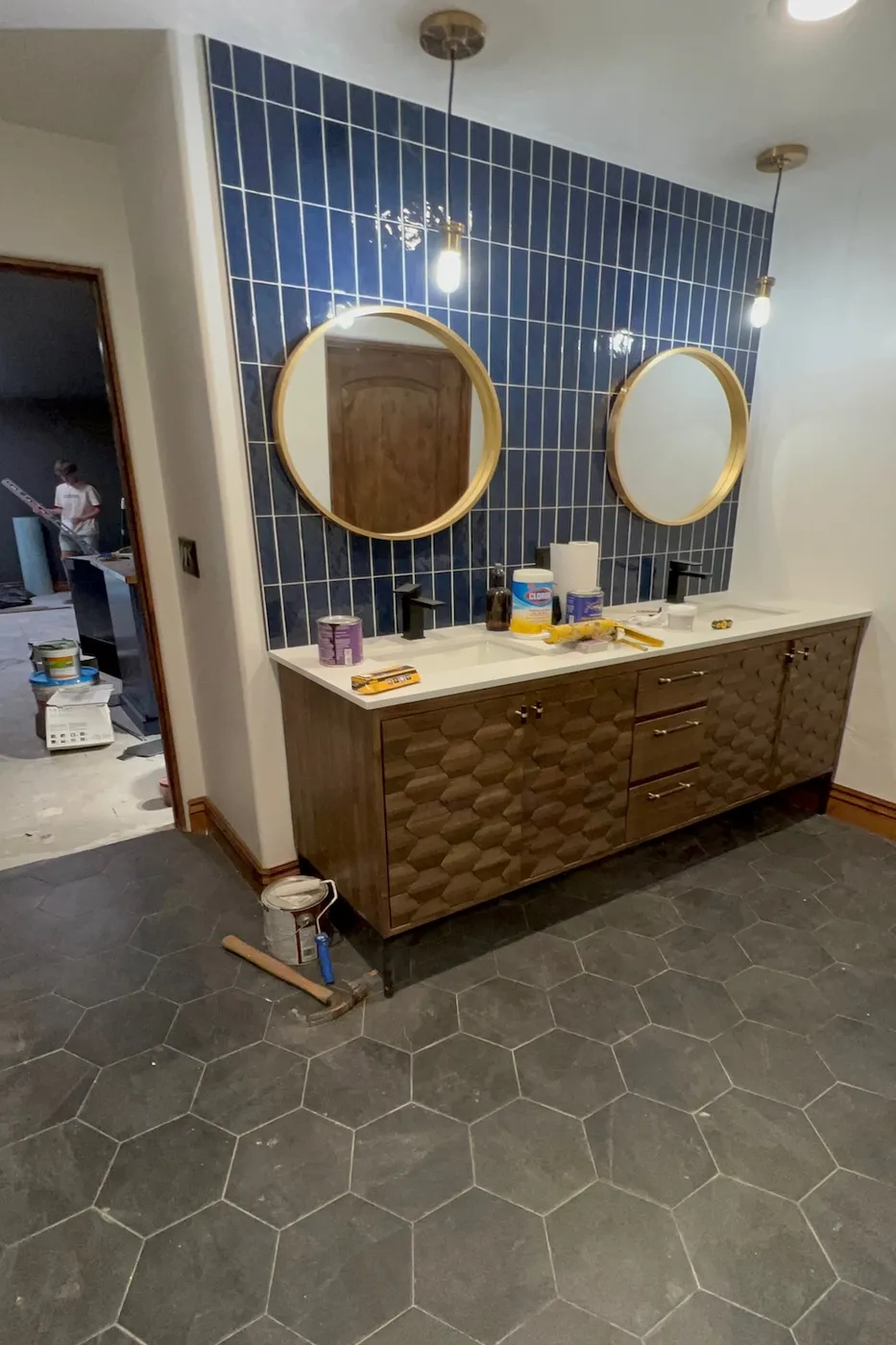 Finished basement bathroom with double vanity and navy tile in Boise