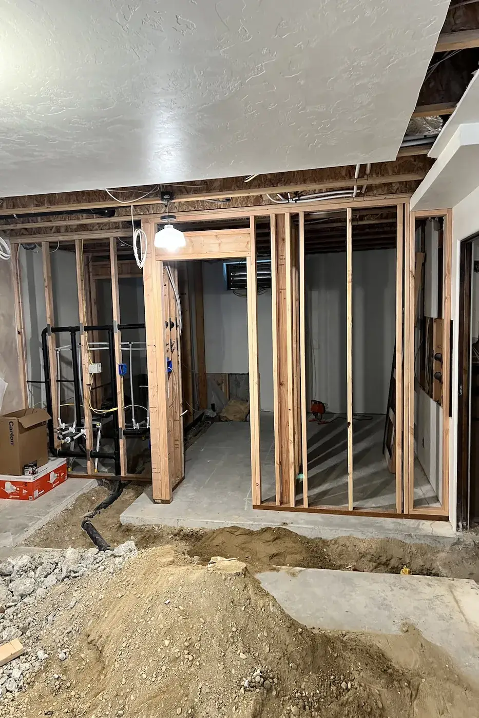 Basement wall framing and rough plumbing during renovation in Boise