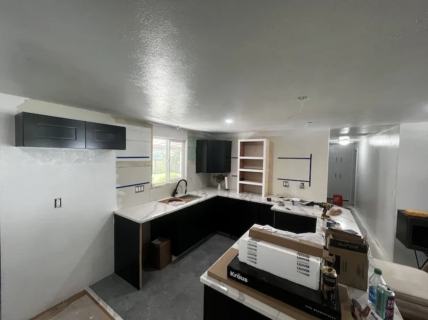Kitchen renovation in progress showing new cabinetry and countertops
